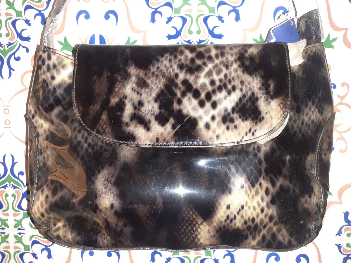 Handmade women's handbag with sturdy handles, featuring a stylish design perfect for everyday use.