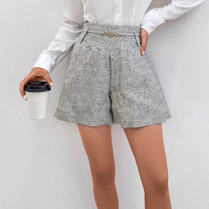 Women's A-line solid-color woven high-waist shorts with metal buckles, front view
