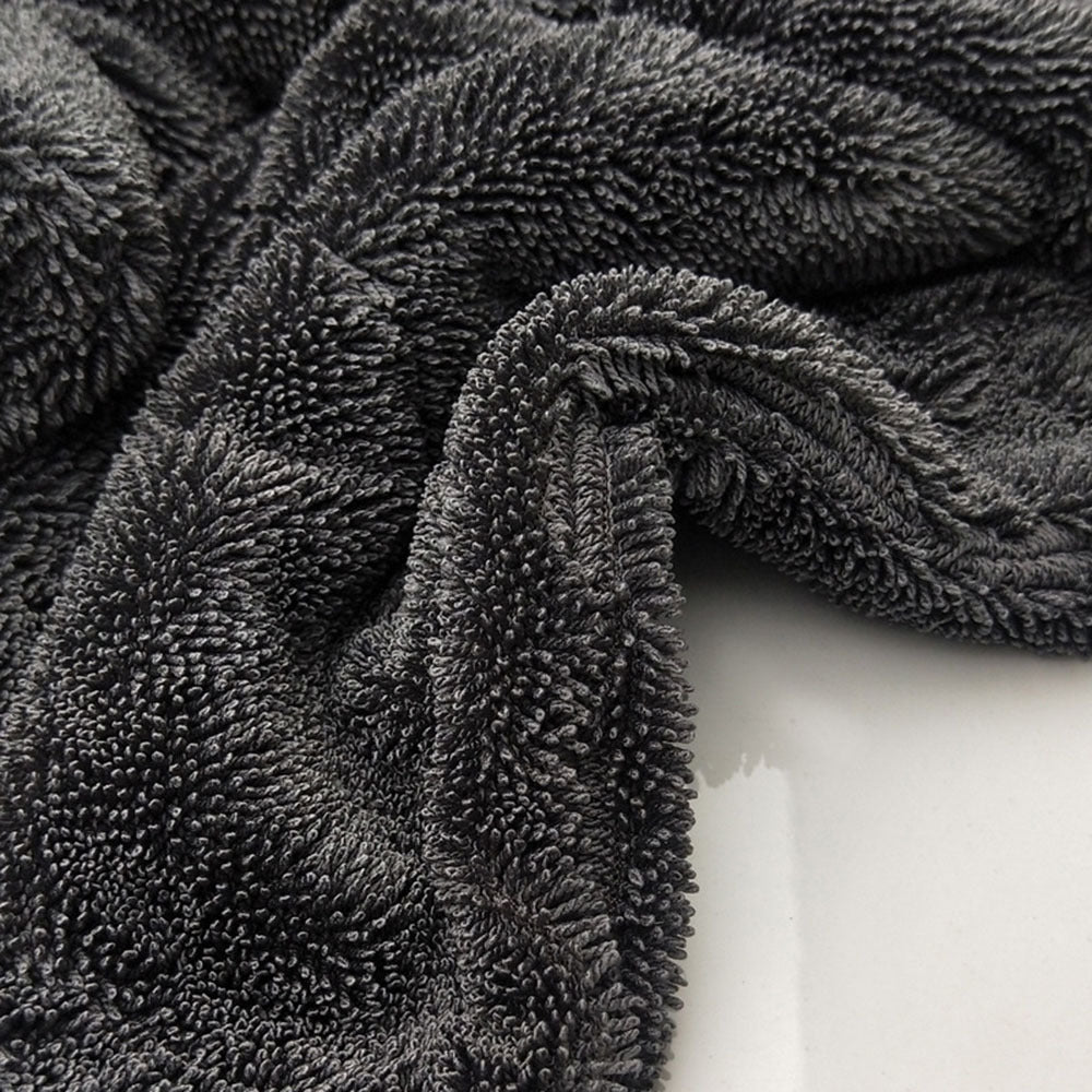 Microfiber absorbent car wash towel folded for vehicle cleaning, soft textured fabric visible