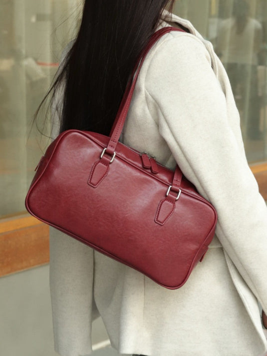 Women's cowhide leather armpit bowling tote handbag in a structured design