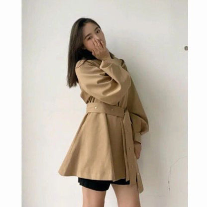Winter and autumn hooded trench coat for women in a long, structured design with button closure