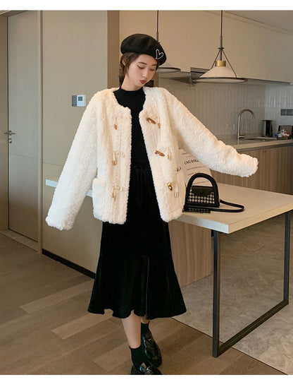 Women's lamb wool fur coat close-up in soft natural wool texture