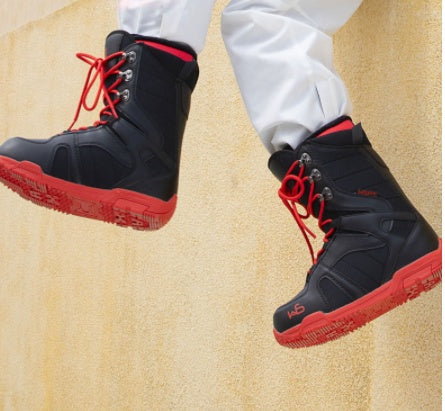Black ski boots with buckles for downhill skiing