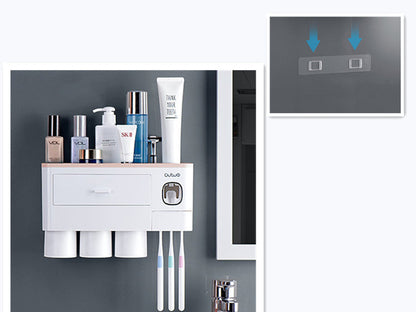 Non-marking hanging magnetic toothbrush holder with single drawer, toothpaste squeezer, and toiletry storage rack