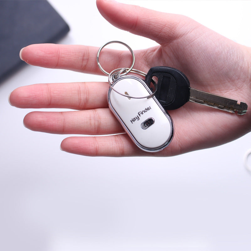 LED whistle control induction key ring elderly key finder anti-lost device on white background