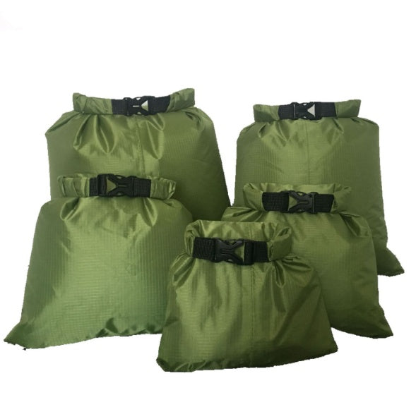 Waterproof dry bags in assorted sizes, durable roll-top design for outdoor gear storage