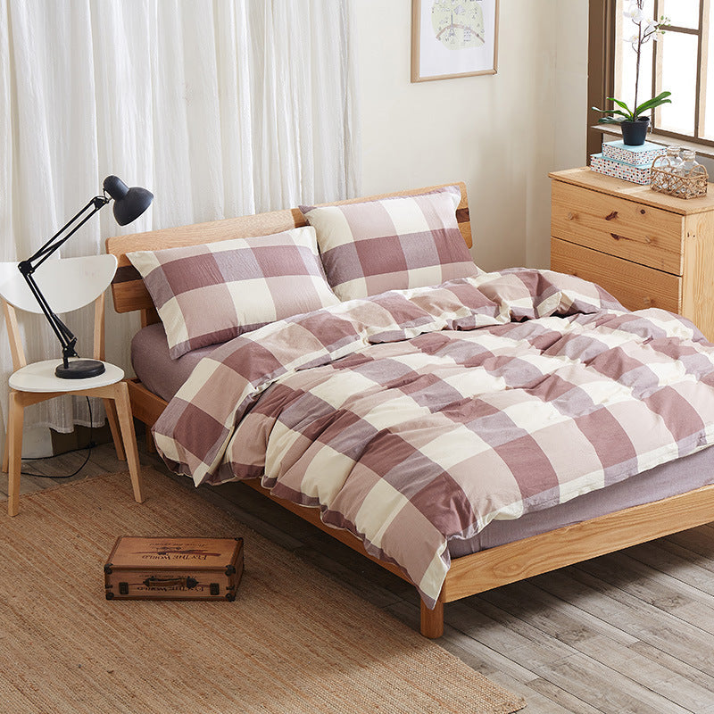 Pure cotton four-piece bed sheet set in soft white fabric, displayed with folded sheets and matching pillowcases