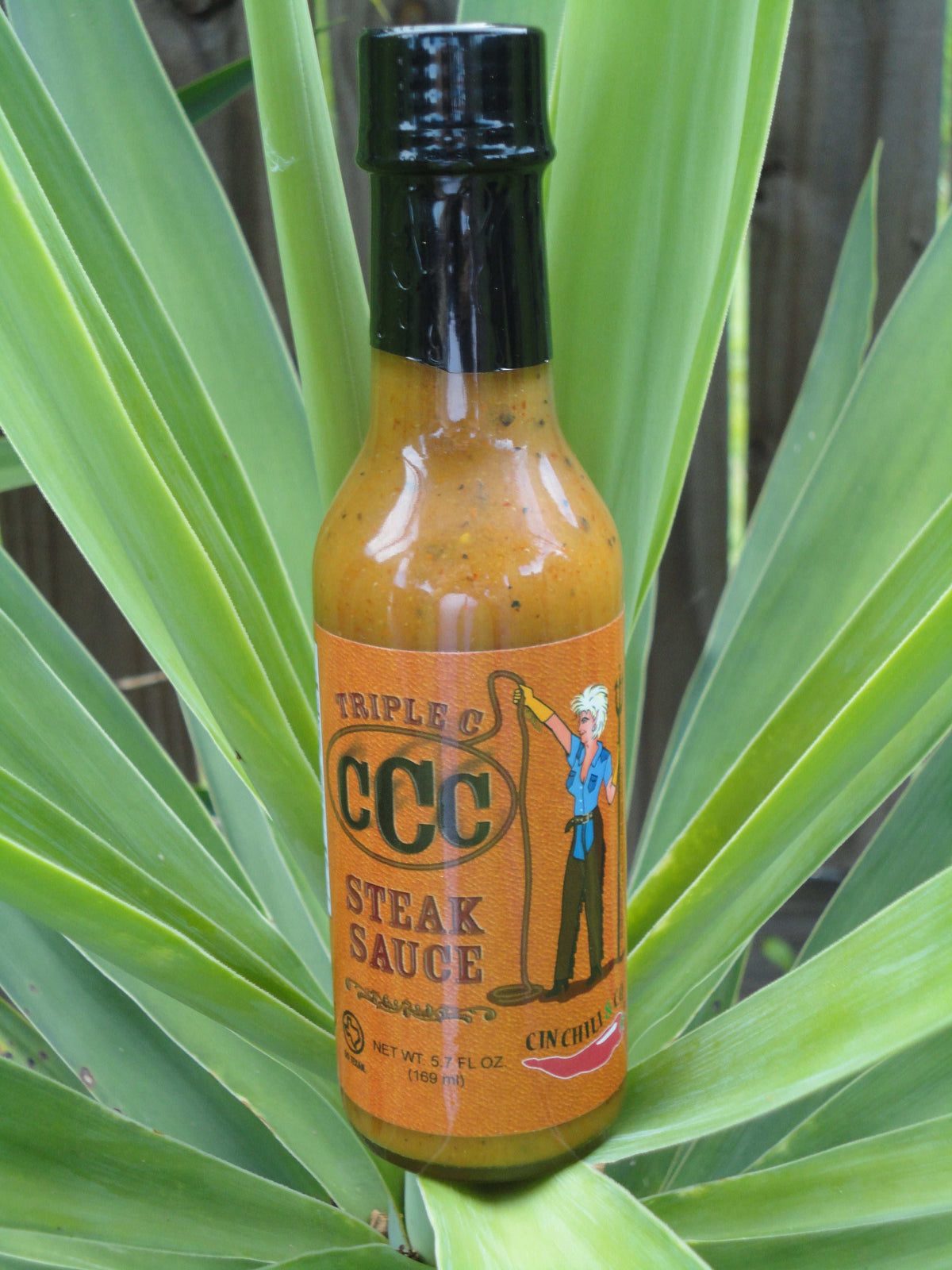 Cinderosa Ranch Triple C Steak Sauce hot sauce bottle with label, featuring bold red and black design and spicy sauce inside.