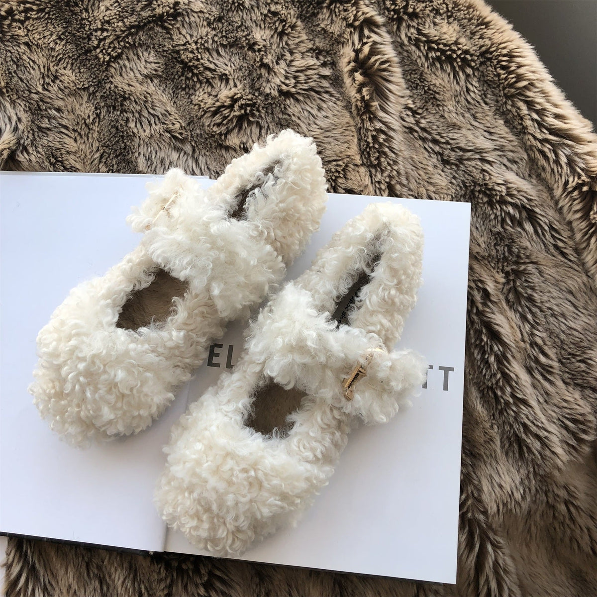 Warm furry shoes in a cozy fuzzy design, shown from the side