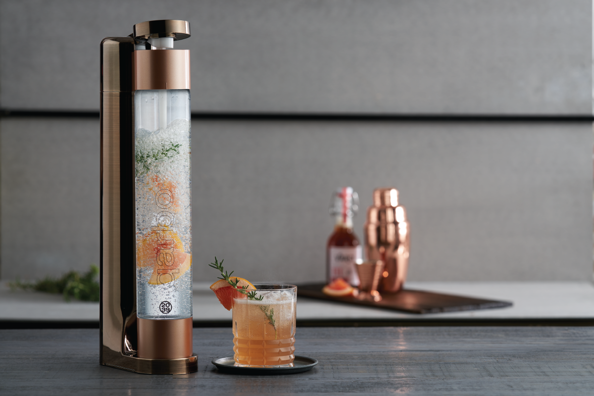 Qarbo FizzMaster sparkling water and fruit infuser in bronze, featuring a sleek design for adding fruit flavors to sparkling water.