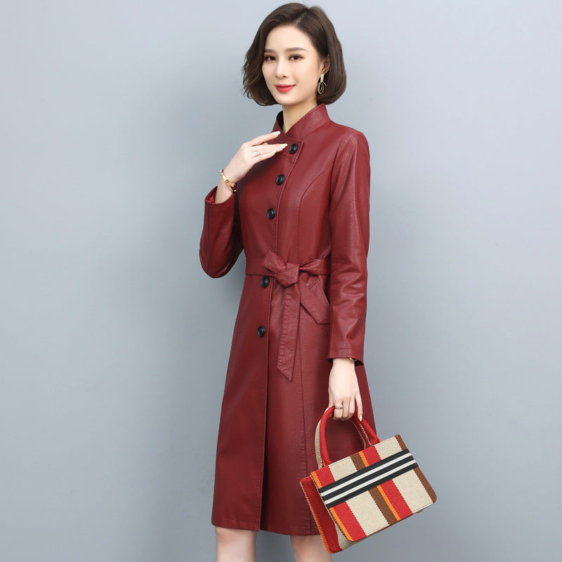 Women's leather trench coat with turn-down collar, drawstring waist, and long loose silhouette in solid color