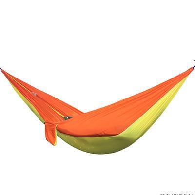 Portable nylon parachute backpacking double hammock suspended outdoors, side view