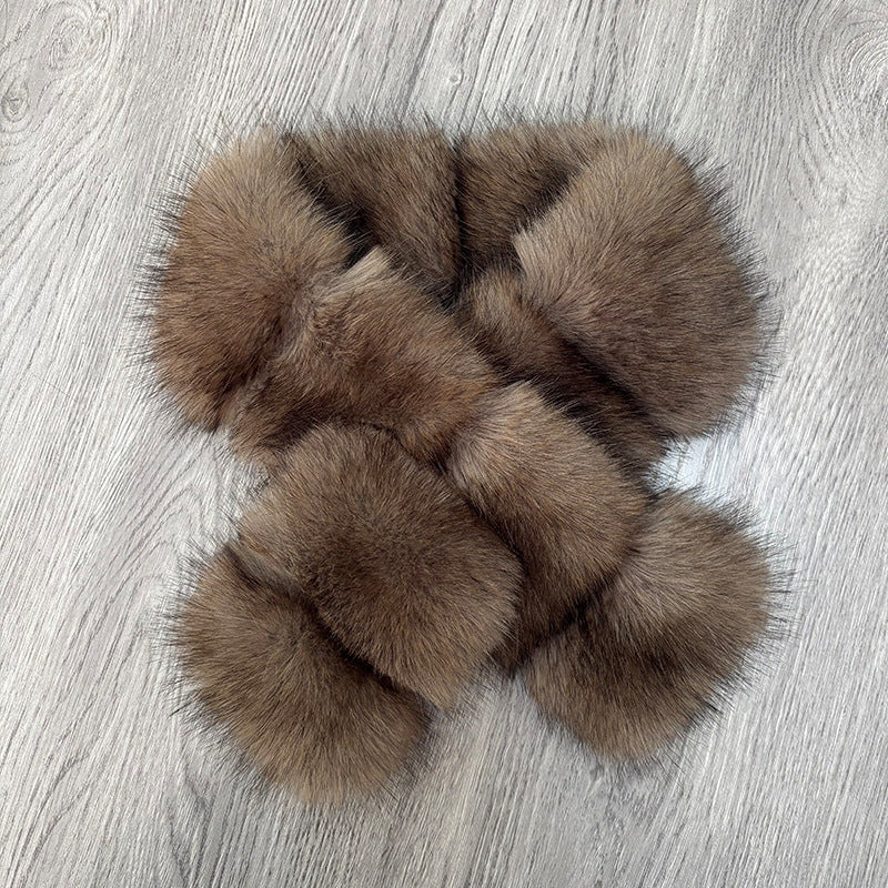 Segmented wool patches and plush materials cross-knitted into a mature, elegant coat with fur detail