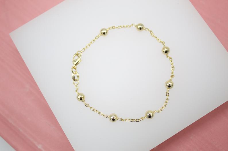 Gold bead chain bracelet by MIA Jewelry featuring small round beads on a delicate gold chain.