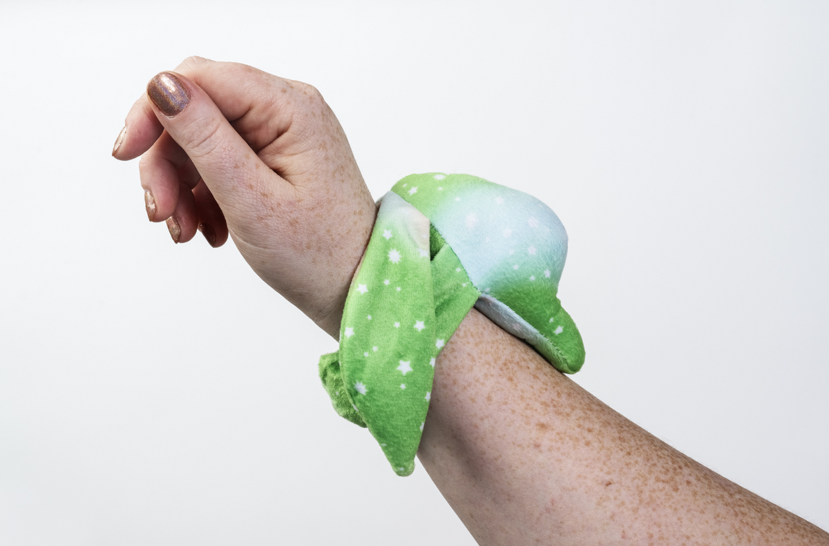 Moon Pals Clover Mini Wrist Hugger Plush toy with soft, colorful fabric, designed for comfortable wrist wear and cuddly comfort.