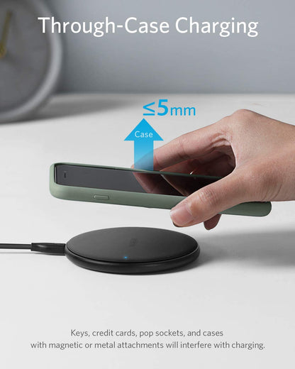 Anker 313 wireless charging pad for Qi-enabled devices with smooth surface and compact design.
