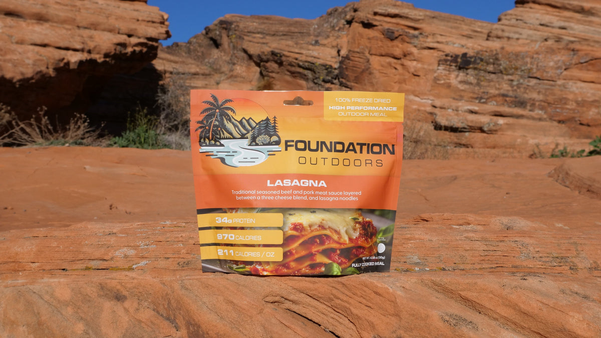 Foundation Outdoors lasagna meal pouch with cooked lasagna layered with sauce and cheese, ready to serve.