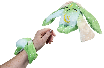 Moon Pals Clover Mini Wrist Hugger plush in soft green with adorable embroidered face and tiny arms, designed as a wrist accessory.