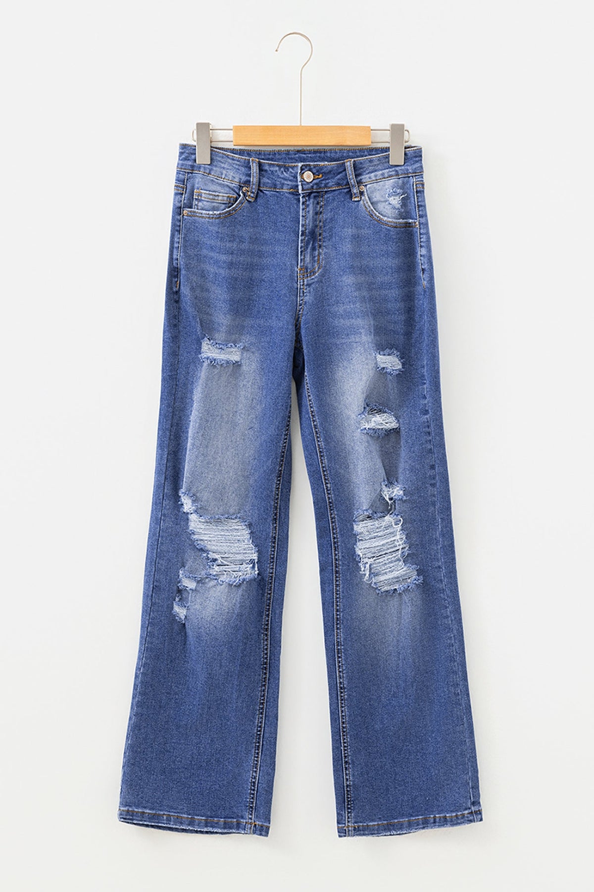 Light blue Hailey Straight Leg Jeans by Threaded Pear hanging on a rack with a classic five-pocket design and raw hem detail.