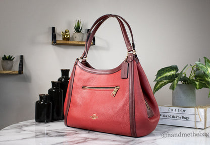 Coach Kristy red leather shoulder bag with triple compartments and apple-shaped design, featuring a sleek, stylish look.