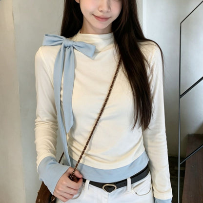 Light blue women's long-sleeved blouse with a bow detail