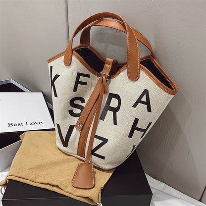 Women's letter printed canvas tote bag by BACKUPMYFILESNOW® with designer style, featuring bold letter graphics on durable fabric.