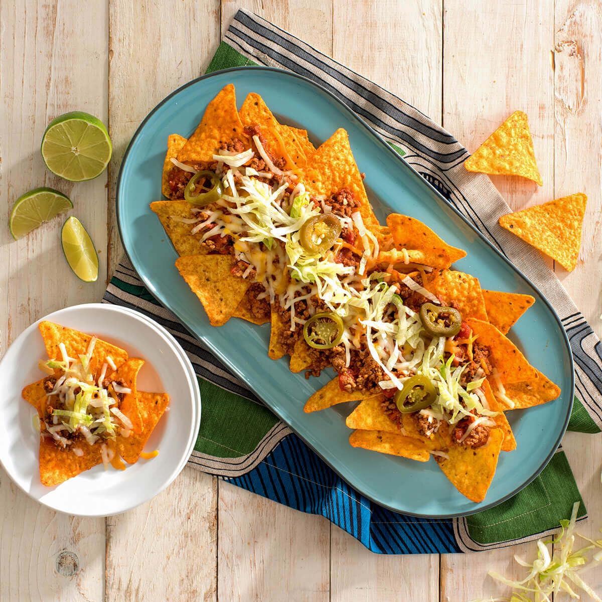 Doritos Nacho Cheese flavored tortilla chips in a 1-ounce pack, shown in a 40-pack display with colorful chips.