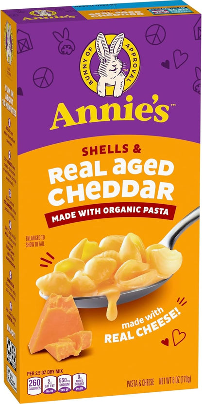 Annie's Homegrown organic shells and white cheddar mac and cheese pack, 4-count, 24 oz box, with cooked pasta and cheese sauce visible