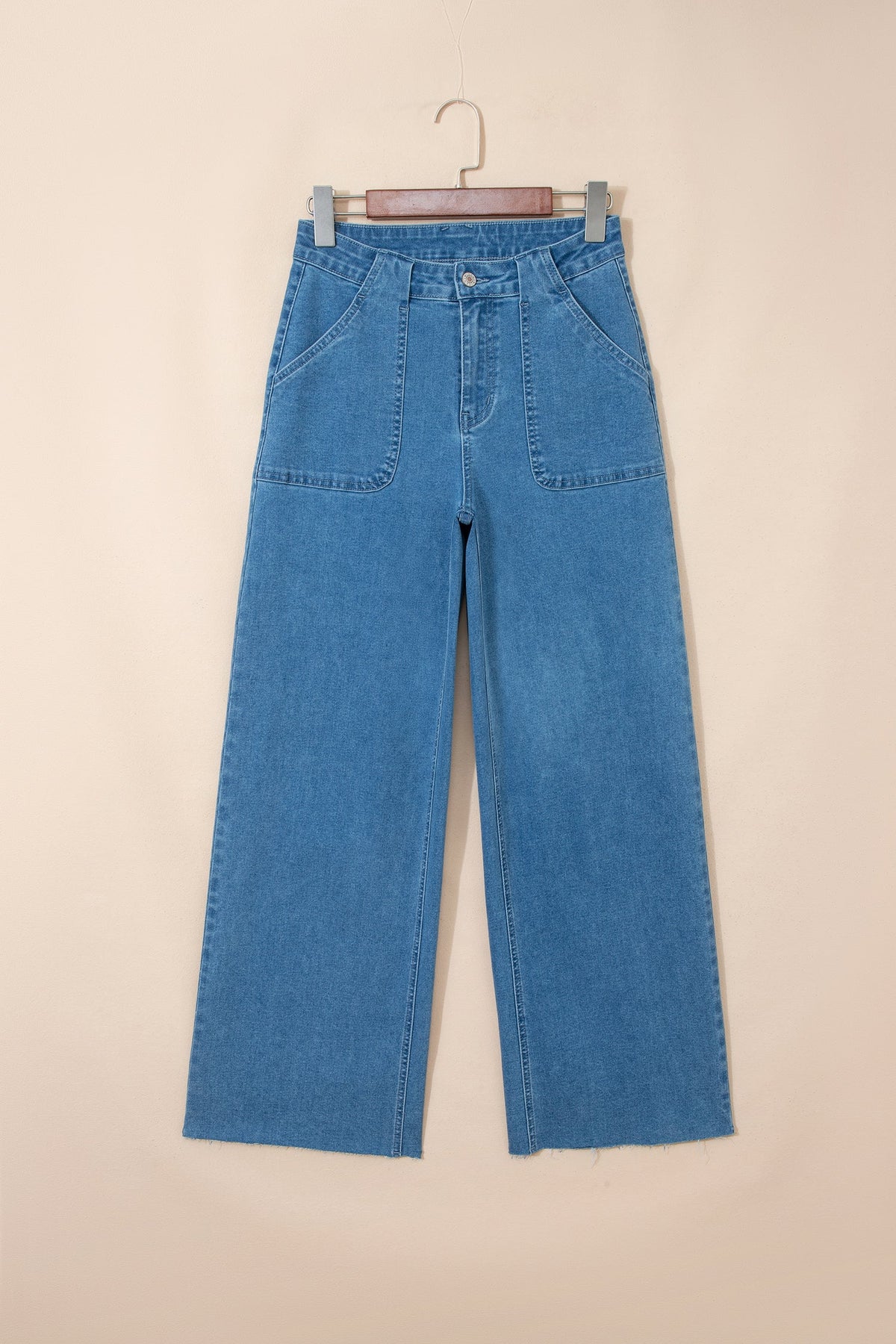 Stretchy blue Lucie Patch jeans by Threaded Pear featuring patchwork details and a fitted waist, perfect for casual wear.