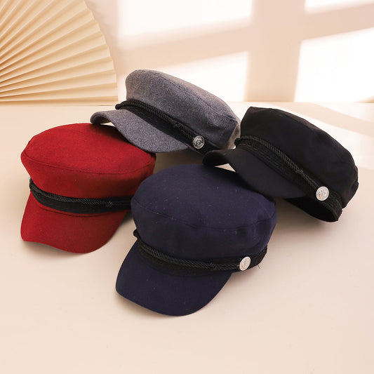 English-style vintage navy newsboy cap with lace edging, braided rope, and silver anchor button