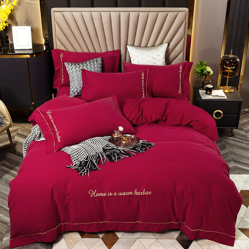 Brushed bedding set in soft textured fabric, neatly arranged in a neutral bedroom setting