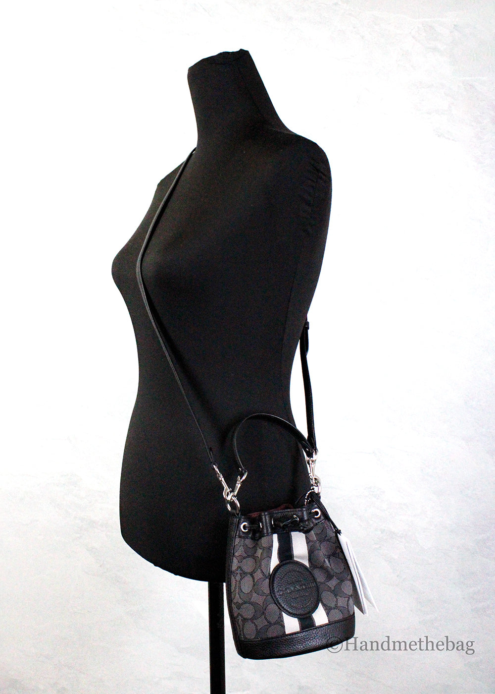 Coach Dempsey Mini Black Jacquard Canvas Patch Crossbody Bucket bag with adjustable strap and patchwork design.