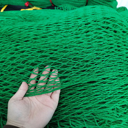 Green golf net displayed outdoors for golf practice and ball containment