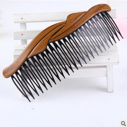 Retro fashion hair comb with decorative vintage-style design, photographed on a clean background