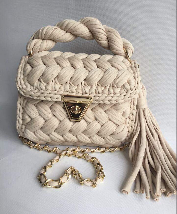 Handwoven women's minimalist tote bag in a natural woven texture with sturdy handles