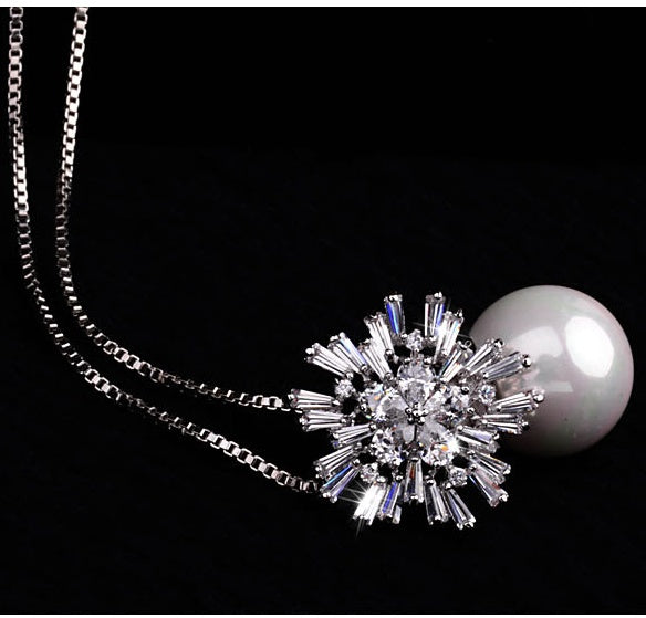Pearl zircon necklace with a delicate design and shimmering zircon accents shown on a plain background