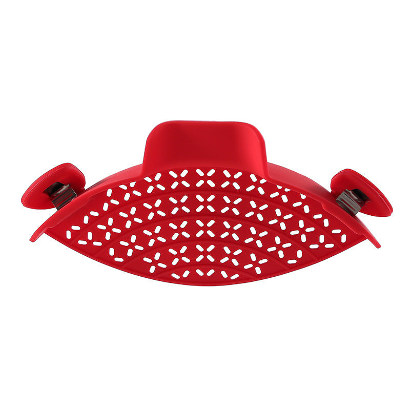 Silicone pot side drain stopper for kitchen use, shown attached to a cooking pot