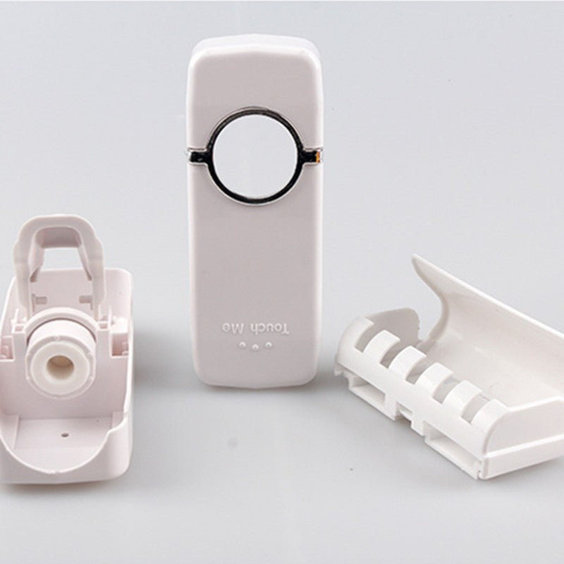 Automatic toothpaste squeezer dispenser in white plastic design with wall-mount bracket