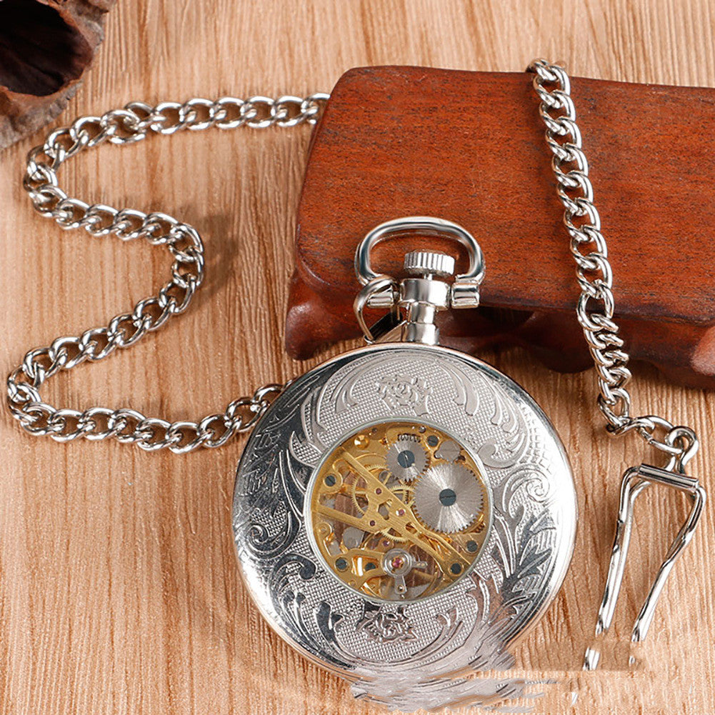 Carved mechanical pocket watch with ornate engraved case and visible winding crown