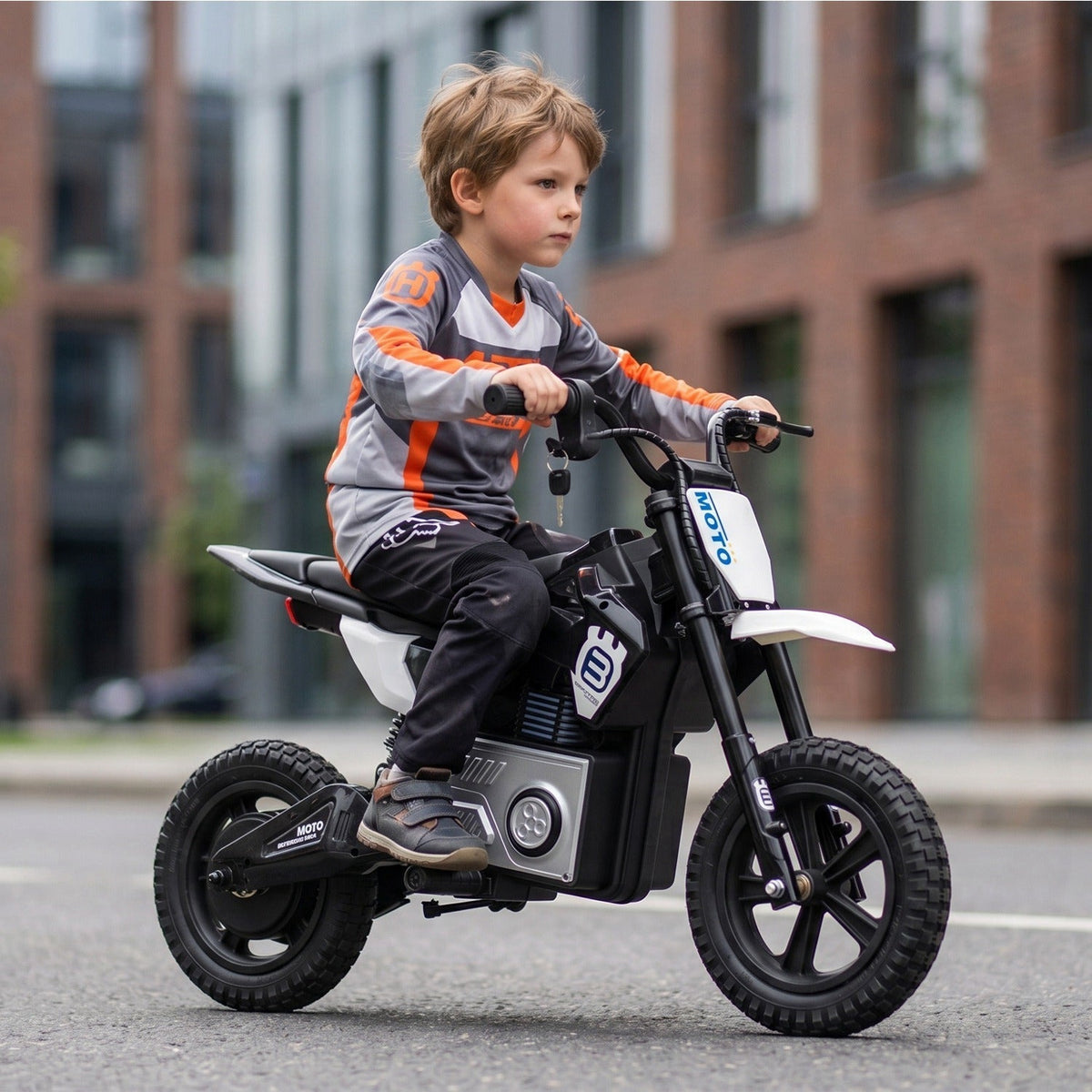 Kids riding a 24V GBruno Store electric motocross ride-on motorcycle for children ages 5-12 outdoors.