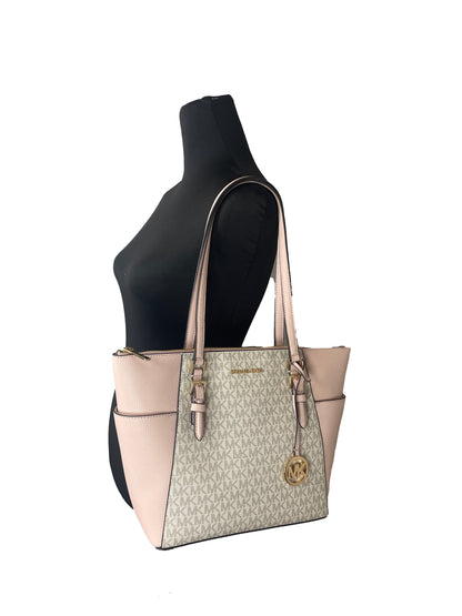 Michael Kors Charlotte Zip Leather Tote in black with gold hardware, showing its sleek design and spacious interior.