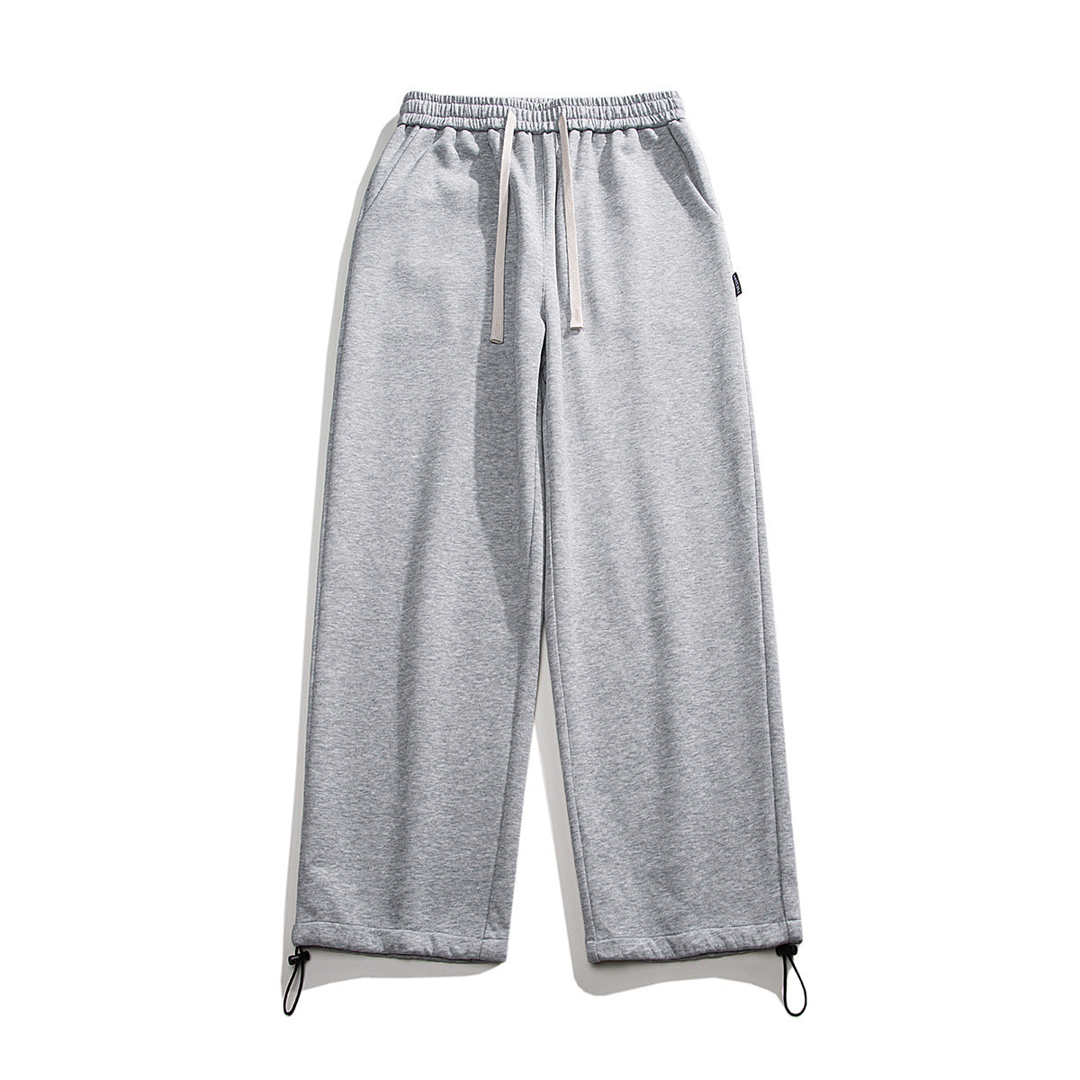Drawstring ankle-tied loose straight sweatpants in a relaxed fit, shown in detail