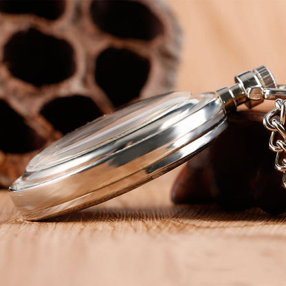 Carved mechanical pocket watch with detailed engraved cover and classic metal finish