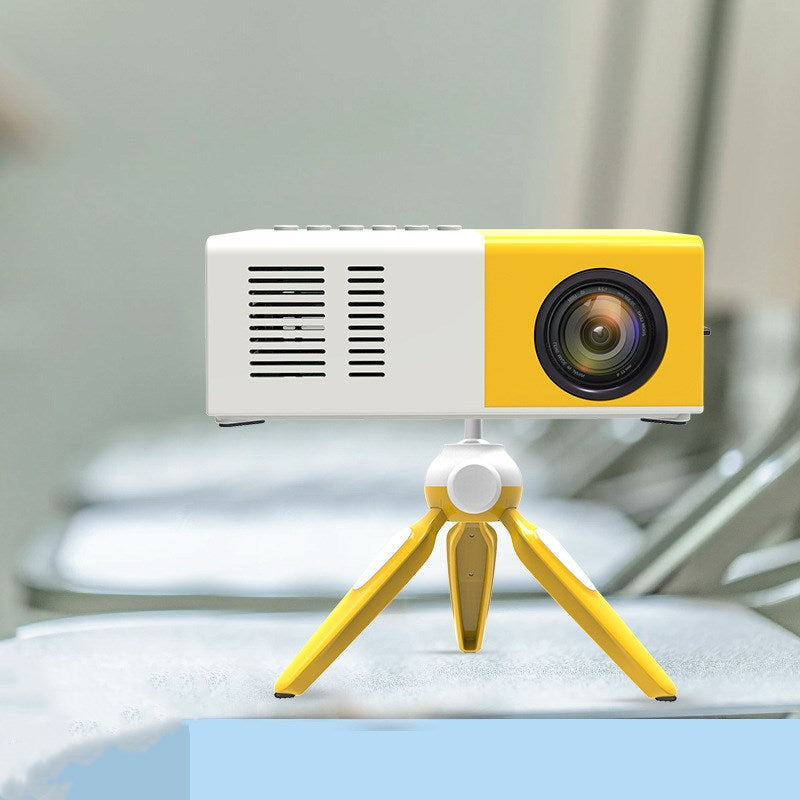 Handheld mini LED home entertainment projector for gifts, compact design with lens and control buttons