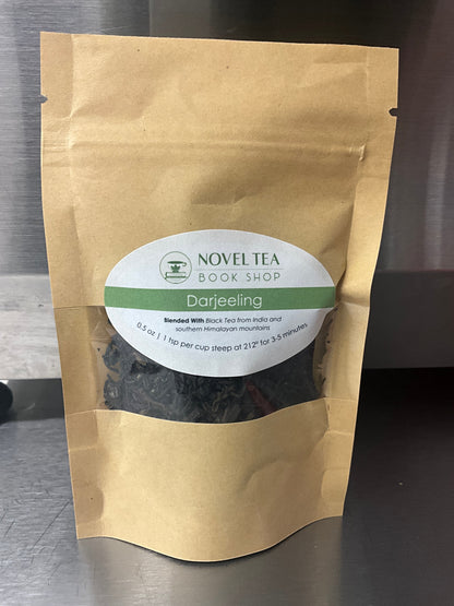 Loose leaf Darjeeling Sungma Summer Black Tea in a clear jar, showcasing dark tea leaves from Novel Tea Book Shop