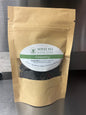 Loose leaf Darjeeling Sungma Summer Black Tea in a clear jar, showcasing dark tea leaves from Novel Tea Book Shop