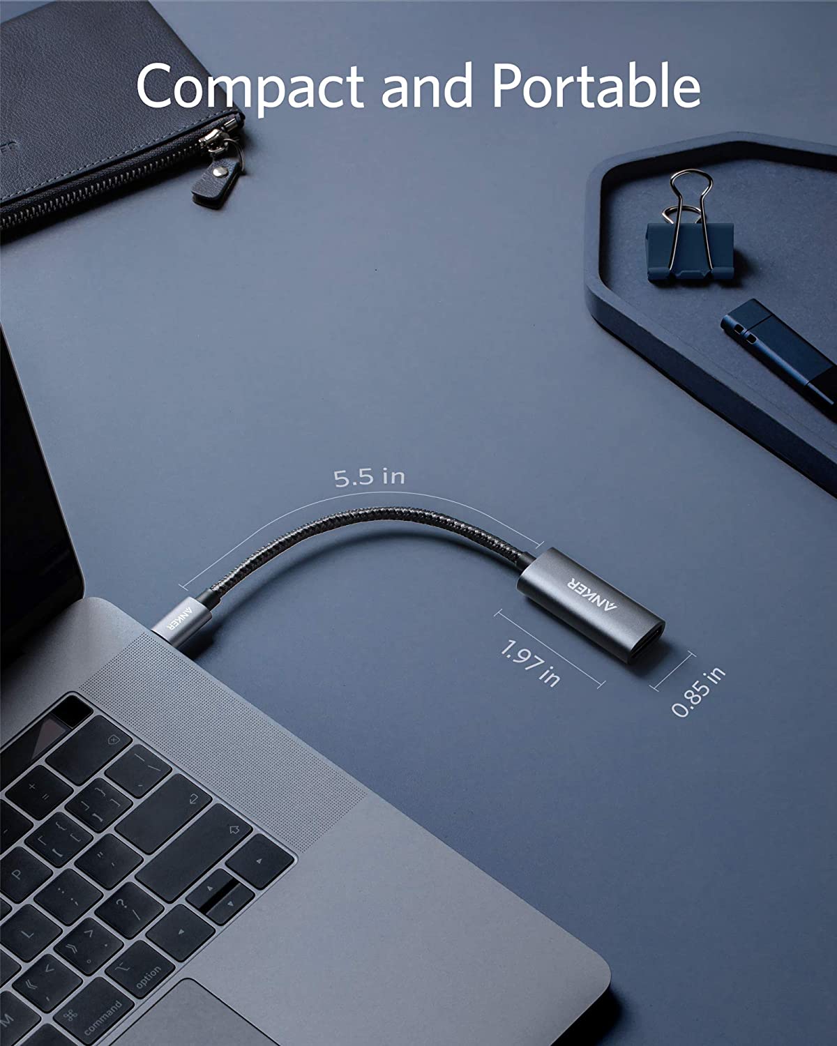 Anker PowerExpand USB-C to DisplayPort adapter connected to a laptop, showing a clear display of the adapter's ports and connected cable.