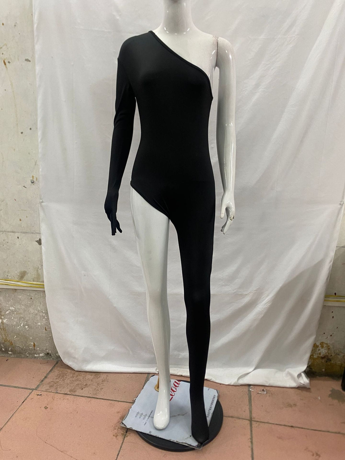 One-shoulder jumpsuit with slimming leg-revealing design in a sleek, fitted silhouette