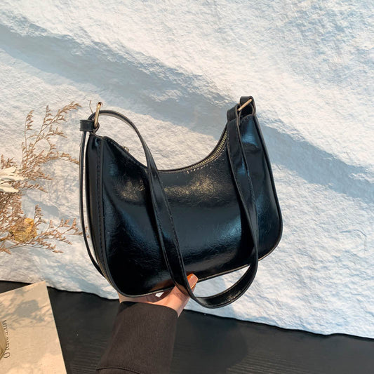 Women's solid-colored vintage fashion handbag in a classic structured design