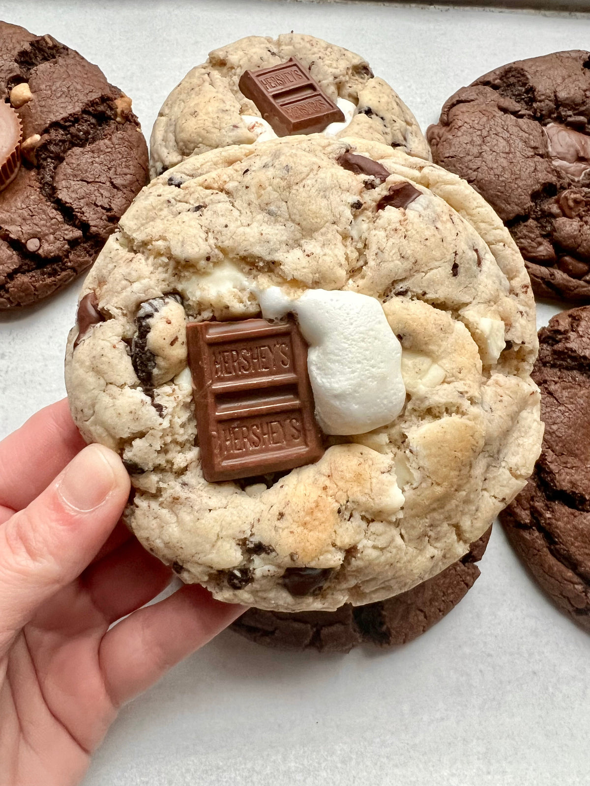 Let's Get Baked Artisan Desserts S'moreo cookies with chocolate and marshmallow filling on a plate